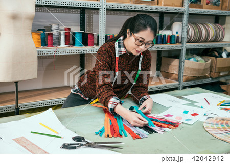 fashion designer choosing zipper 42042942