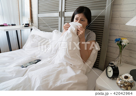 woman lie in her bed and afraid see bloody scene woman lie in her bed and afraid see bloody scene 42042964