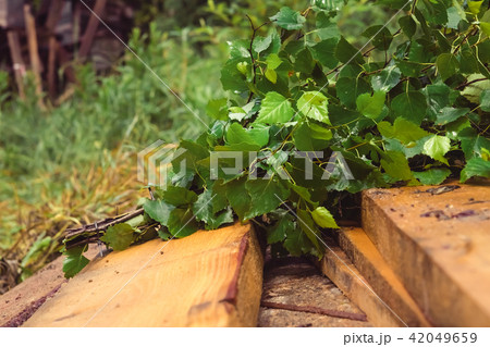 Birch broom lying on brown wooden porch Birch broom lying on brown wooden porch 42049659