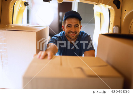 Delivery guy taking boxes out of van. Delivery guy taking boxes out of van. 42049856