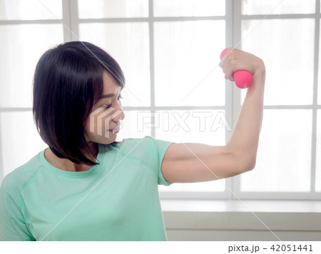 Young girl lifting dumbbells Young girl lifting dumbbells 42051441