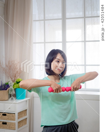 Young girl lifting dumbbells Young girl lifting dumbbells 42051484