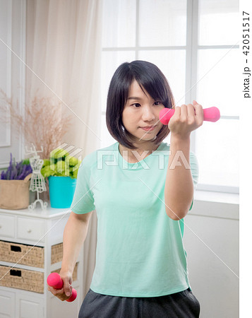 Young girl lifting dumbbells Young girl lifting dumbbells 42051517