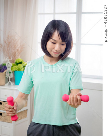 Young girl lifting dumbbells  42051527