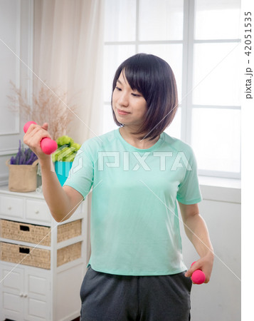 Young girl lifting dumbbells  42051535