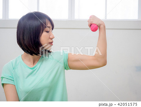 young girl lifting dumbbells  42051575