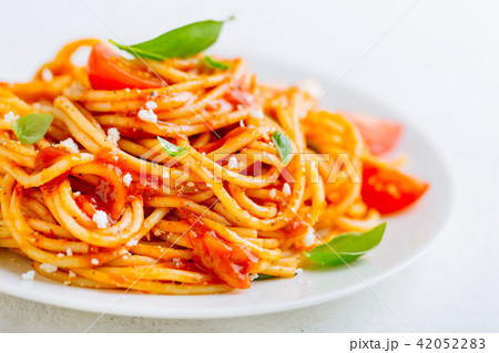 Pasta dish with tomato sauce on white plate 42052283
