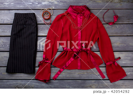 Black trousers and red blouse, flat lay. 42054292