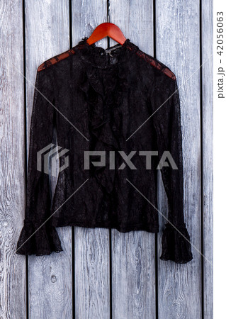 Black lace blouse on hanger. 42056063