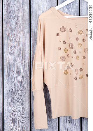 Beige women's blouse sleeve, top view. Beige women's blouse sleeve, top view. 42056356