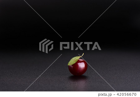 Ripe sweet cherry with leaf isolated on black Ripe sweet cherry with leaf isolated on black 42056670