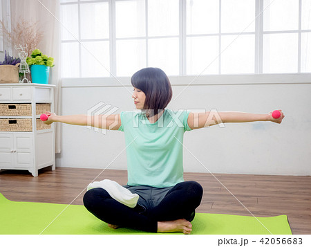 Young girl lifting dumbbells Young girl lifting dumbbells 42056683