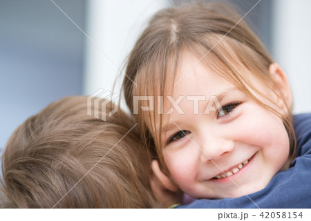 Little girl is embracing her brother 42058154