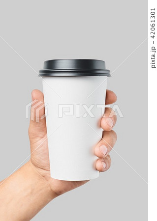 Mockup of men's hand holding white paper large size cup with black cover Mockup of men's hand holding white paper large size cup with black cover 42061301