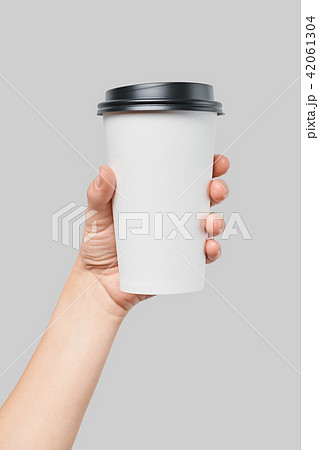 Mockup of women's hand holding white paper large size cup with black cover Mockup of women's hand holding white paper large size cup with black cover 42061304