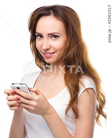Young woman is typing sms message on her phone Young woman is typing sms message on her phone 42062017