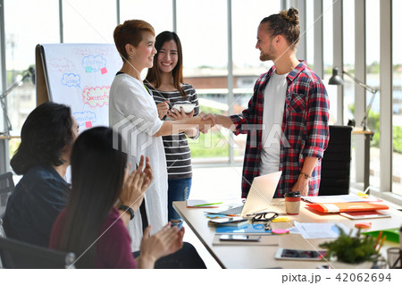 Two businesspersons shaking hands in agreement Two businesspersons shaking hands in agreement 42062694