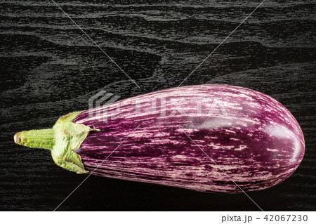 Fresh raw striped Eggplant on black wood Fresh raw striped Eggplant on black wood 42067230
