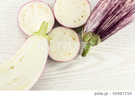 Fresh raw striped Eggplant on grey wood Fresh raw striped Eggplant on grey wood 42067250