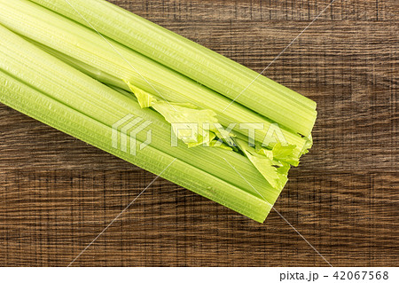 Fresh Celery isolated on brown wood Fresh Celery isolated on brown wood 42067568
