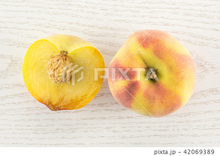 Fresh Raw yellow peach on grey wood Fresh Raw yellow peach on grey wood 42069389