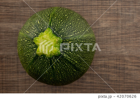 Fresh raw round Zucchini on brown wood Fresh raw round Zucchini on brown wood 42070626