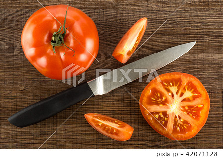 Fresh raw Tomato (La Parcela) on black wood Fresh raw Tomato (La Parcela) on black wood 42071128