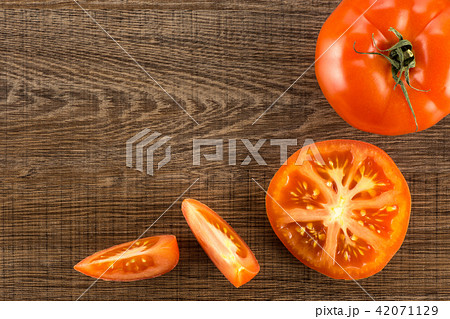 Fresh raw Tomato (La Parcela) on black wood Fresh raw Tomato (La Parcela) on black wood 42071129