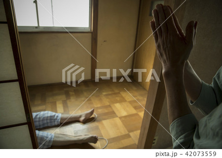 和室に横たわる男性の足　 42073559