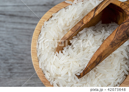 Thai Jasmine white rice in wooden scoop Thai Jasmine white rice in wooden scoop 42073648