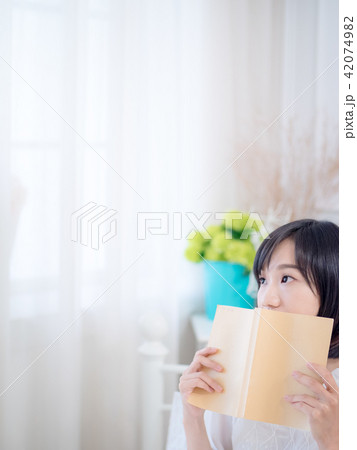 Portrait of a beautiful woman reading a book 42074982