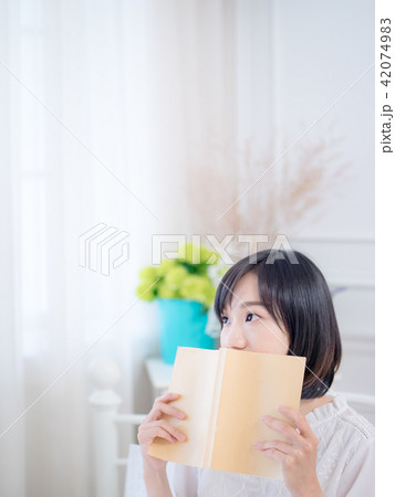 Portrait of a beautiful woman reading a book 42074983