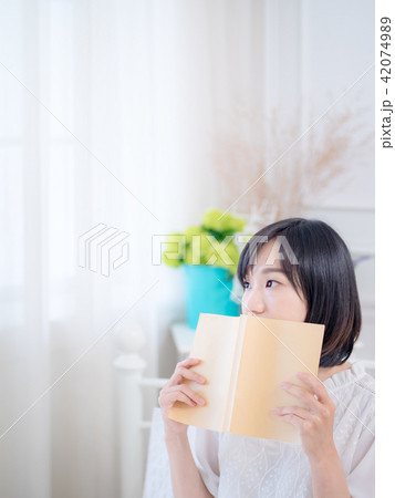 Portrait of a beautiful woman reading a book 42074989