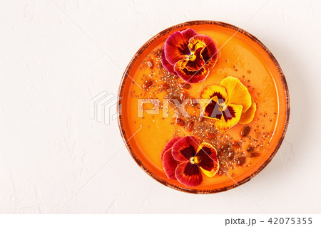 Smoothie bowl with edible pansy flowers, chia  42075355