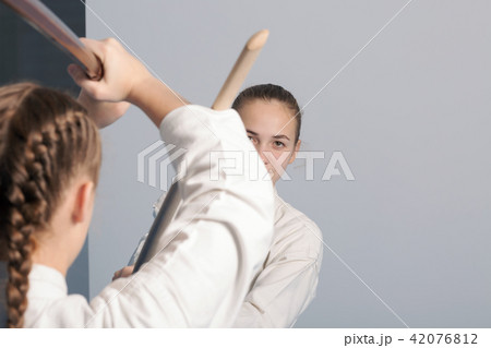 Two girls practice sword on Aikido training Two girls practice sword on Aikido training 42076812