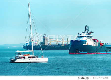 Freight ships and white yacht 42082986