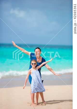 Beautiful mother and daughter on Caribbean beach Beautiful mother and daughter on Caribbean beach 42085361
