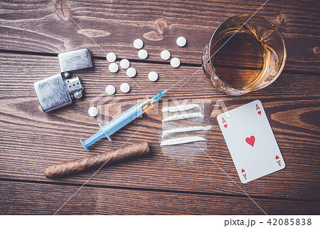 Hard drugs with pills, playing cards and syringe Hard drugs with pills, playing cards and syringe 42085838