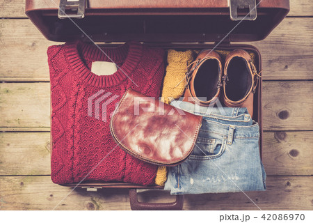 Open suitcase with casual female clothes 42086970