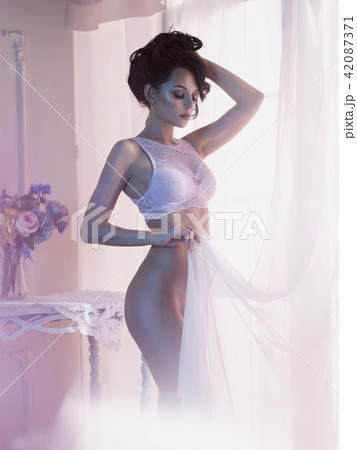 Woman in lingerie at window 42087371