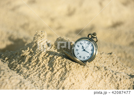 Pocket Watch On Sand With Soft Light In Morning 42087477