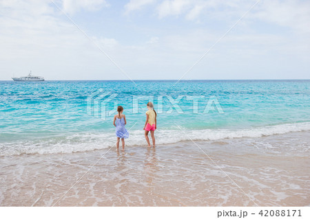 Adorable little girls have a lot of fun on the beach. Adorable little girls have a lot of fun on the beach. 42088171