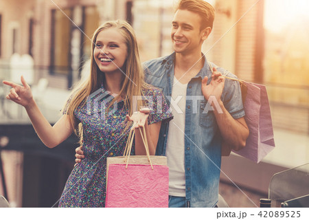 Beautiful Young Couple Holding Shopping Bags 42089525