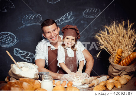Little girl with father making dough 42092587