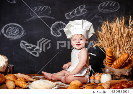 Adorable infant on table with dough 42092605