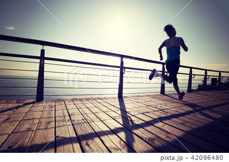 sporty young fitness woman running on coast sporty young fitness woman running on coast 42096480