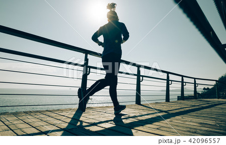 sporty young fitness woman running on coast sporty young fitness woman running on coast 42096557