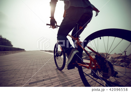 cyclist riding mountain bike in the sunrise coast cyclist riding mountain bike in the sunrise coast 42096558