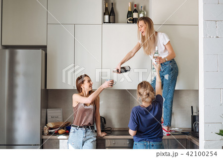 three women with bottles of alcohol three women with bottles of alcohol 42100254