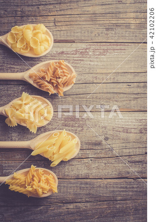Mix of pasta on an old wooden table Mix of pasta on an old wooden table 42102206
